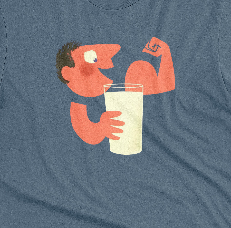 A blue t-shirt with an advertisement for milk featuring a retro cartoon graphic of a muscular man flexing his arm and holding a glass of milk.