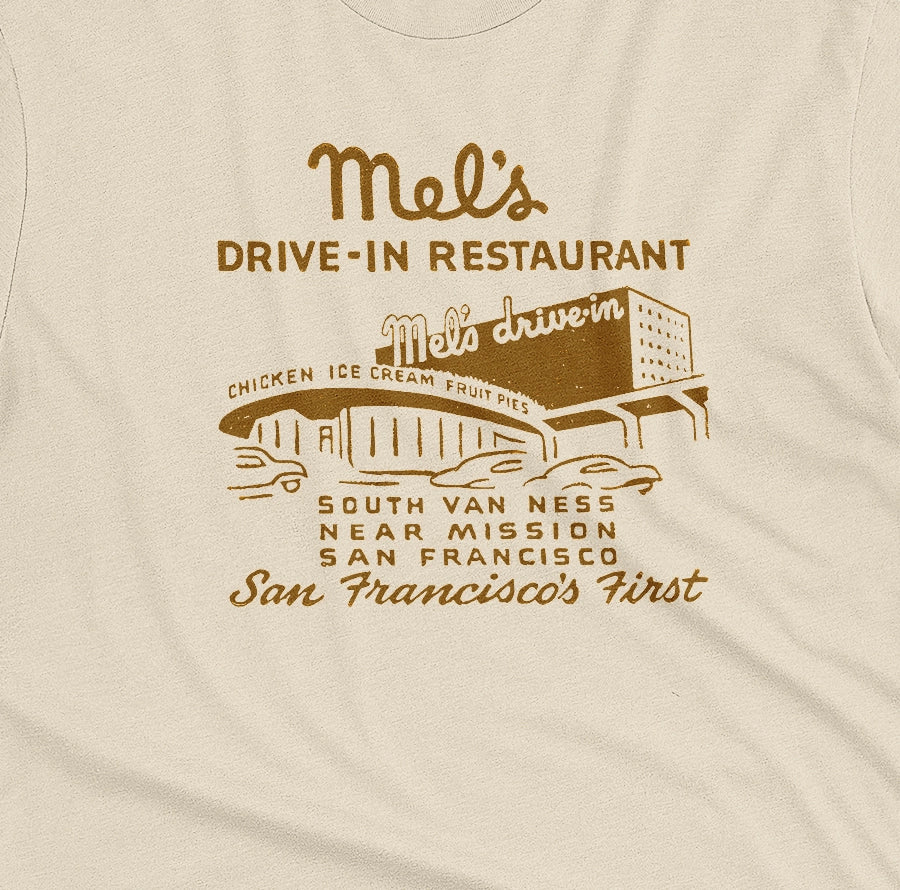 A beige t-shirt featuring an advertisement for 'Mel's Drive-In Restaurant' in San Francisco.