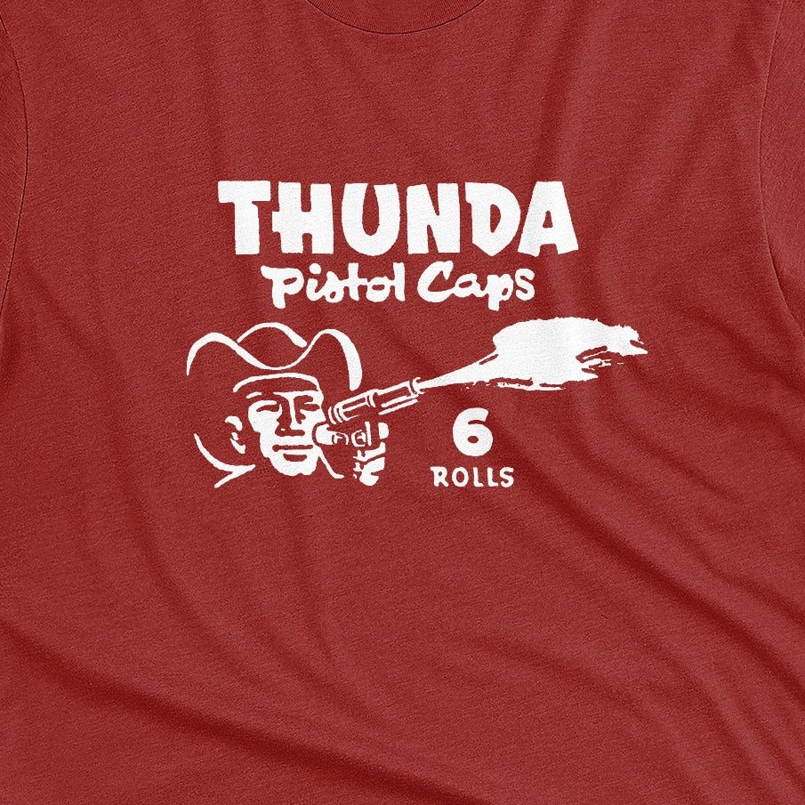 A red t-shirt with retro 1970s packaging graphics for cap gun ammo brand Thunda.