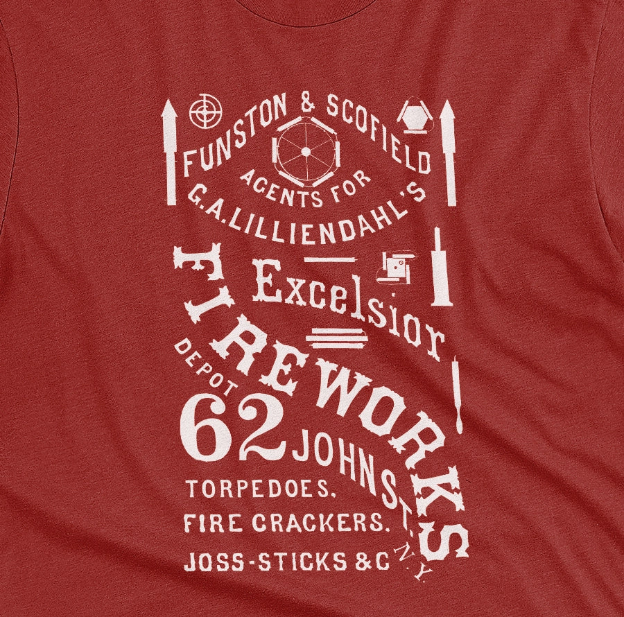 A red t-shirt with a white vintage graphic of Excelsior Fireworks packaging.