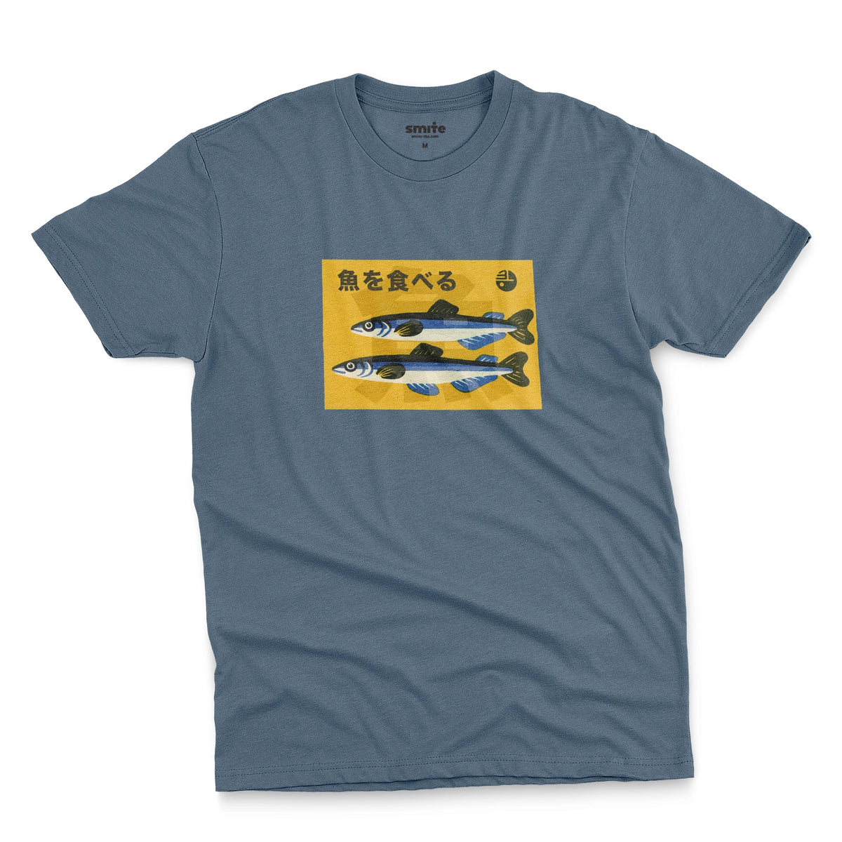 A blue t-shirt with a rectangular graphic print on the chest showing two blue and silver fish on a yellow background with the Japanese text 'Eat Fish'.
