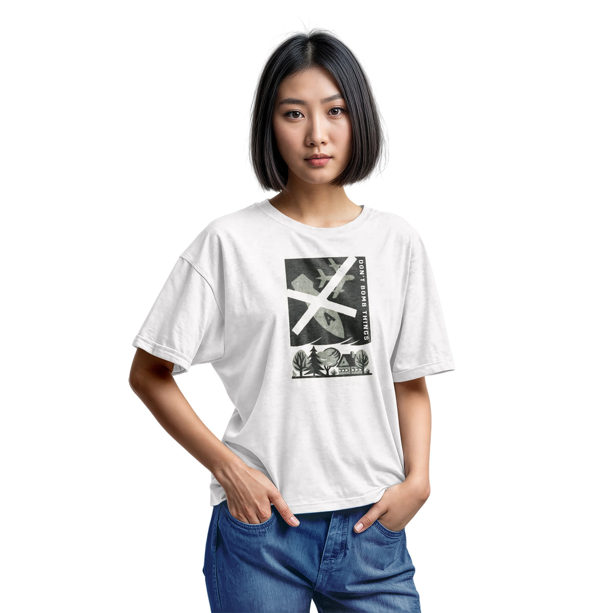 A white t-shirt with a retro graphic print of an anti-war message featuring a cross, a plane, a house, and the text 'DON'T BOMB THINGS'.