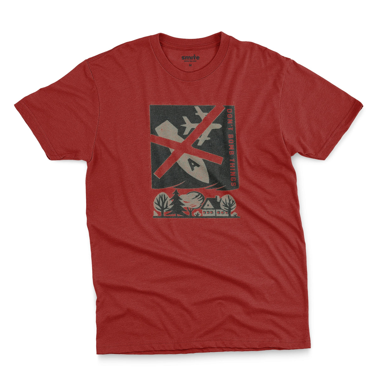 A red t-shirt with a retro graphic print of an anti-war message featuring a cross, a plane, a house, and the text 'DON'T BOMB THINGS'.