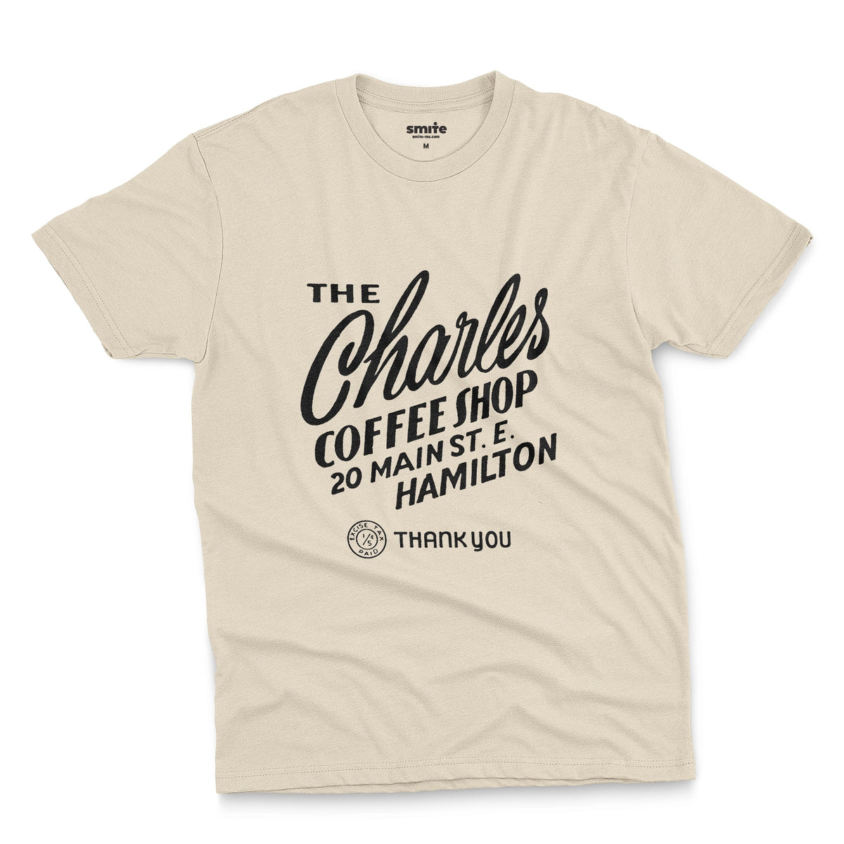 A beige t-shirt with a retro typographic logo for The Charles Coffee Shop in Hamilton.