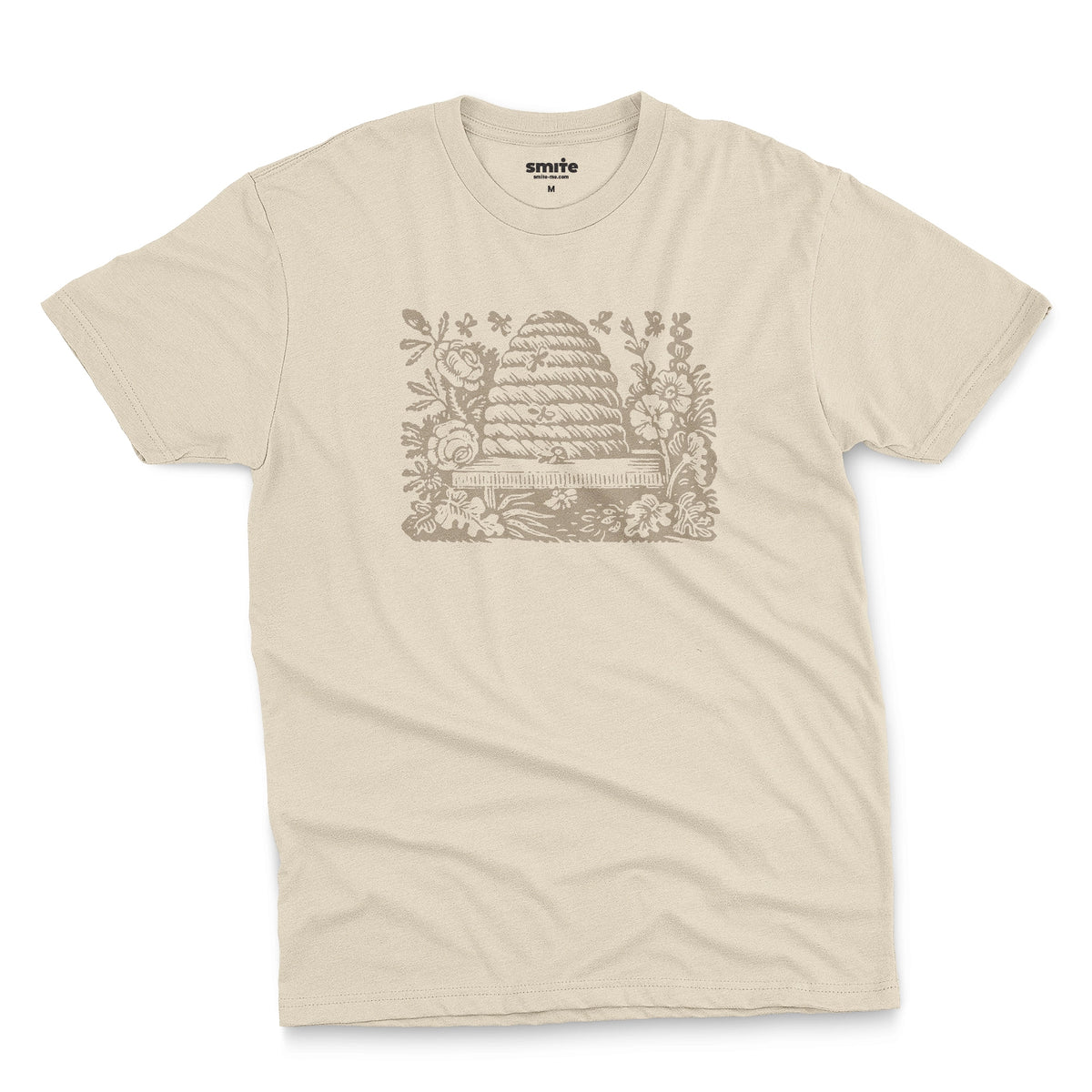 A beige t-shirt featuring a retro engraved graphic print of a beehive surrounded by flowers.