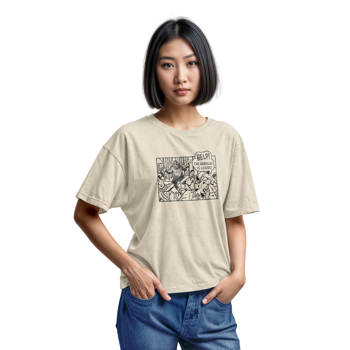 A beige t-shirt featuring a retro comic-style graphic depicting a gorilla and the text 'HELP! THE GORILLA IS LOOSE!'.