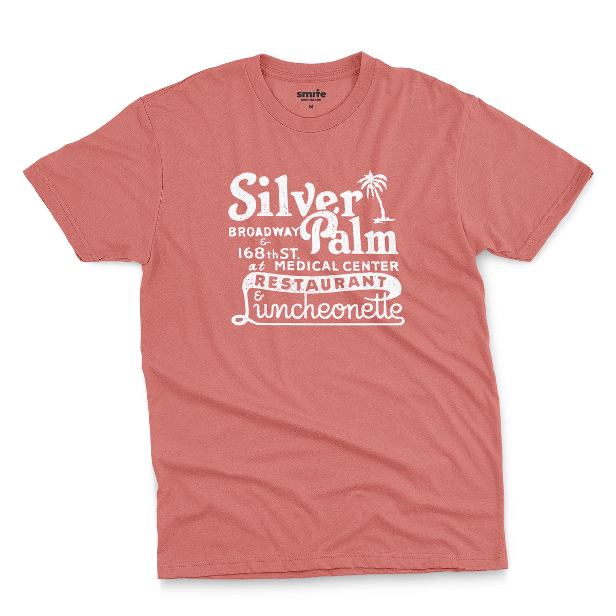 A coral pink t-shirt with a retro advertisement for Silver Palm Restaurant in New York.
