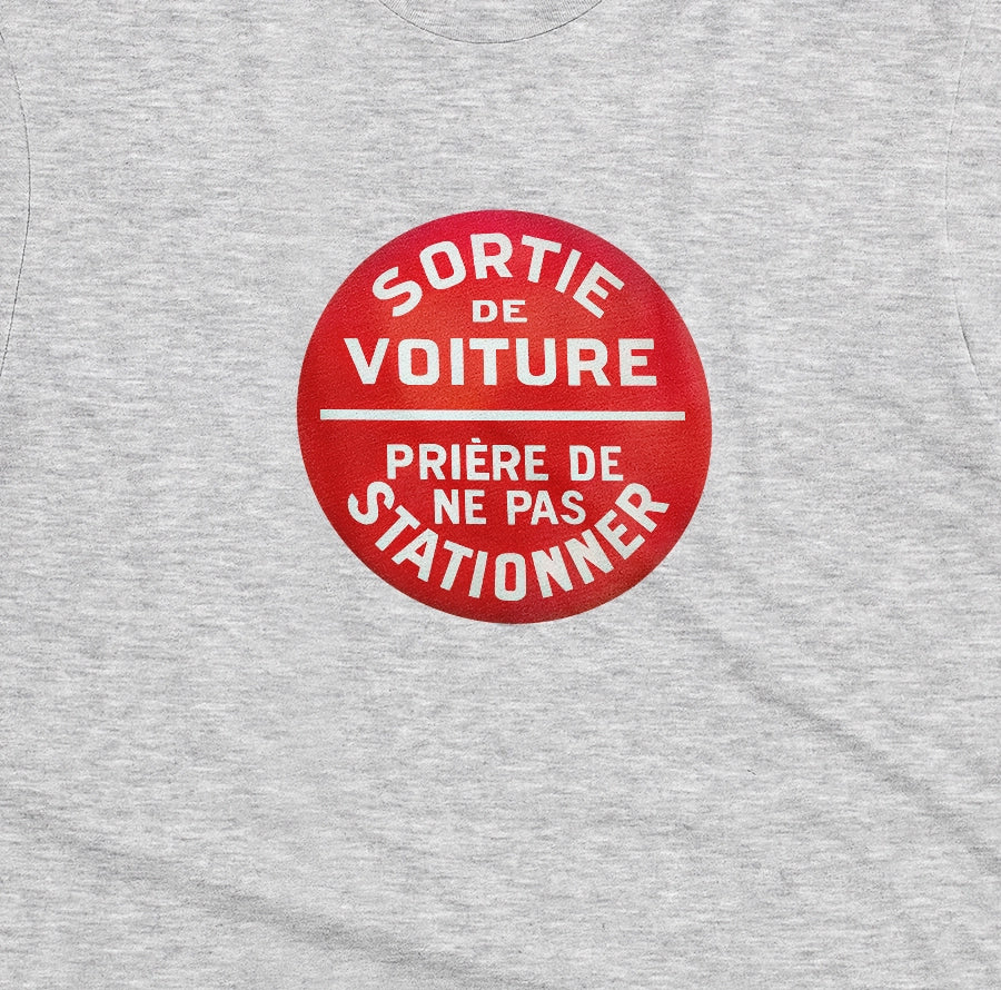 A gray marle t-shirt with a retro red and white graphic on the chest with French text 'SORTIE DE VOITURE PRIERE DE NE PAS STATIONNER'.