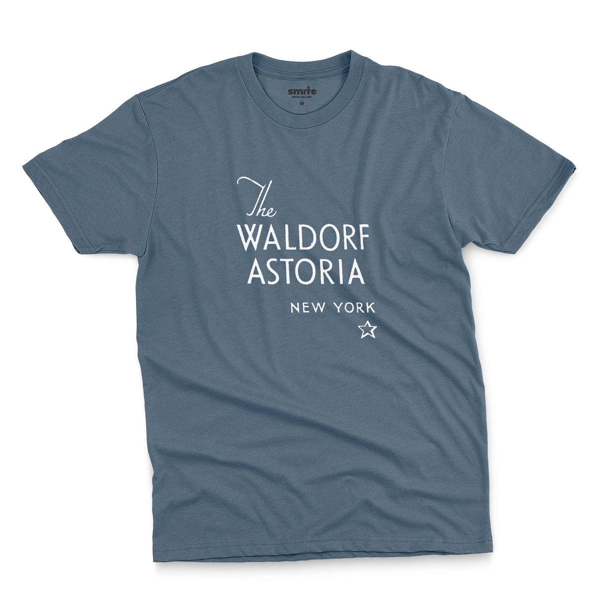 A blue t-shirt with a retro logo for The Waldorf Astoria hotel in New York.