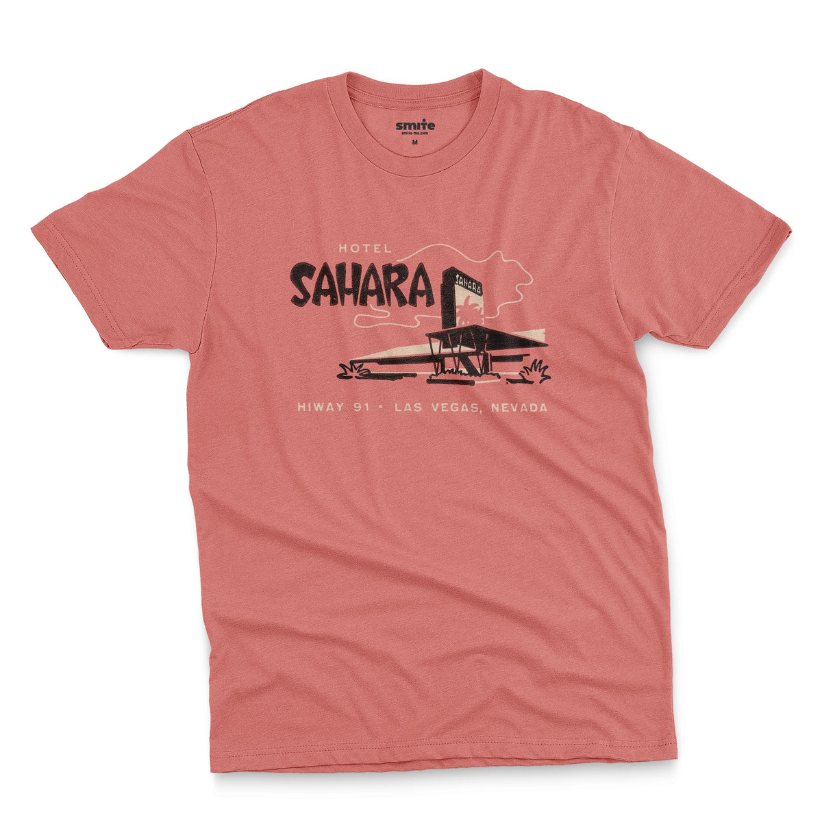 A coral pink t-shirt with a vintage graphic advertising the 'Hotel Sahara' in Las Vegas, Nevada.