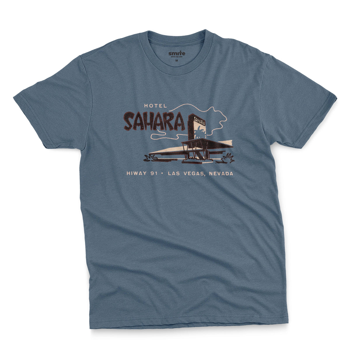 A blue t-shirt with a vintage graphic advertising the 'Hotel Sahara' in Las Vegas, Nevada.