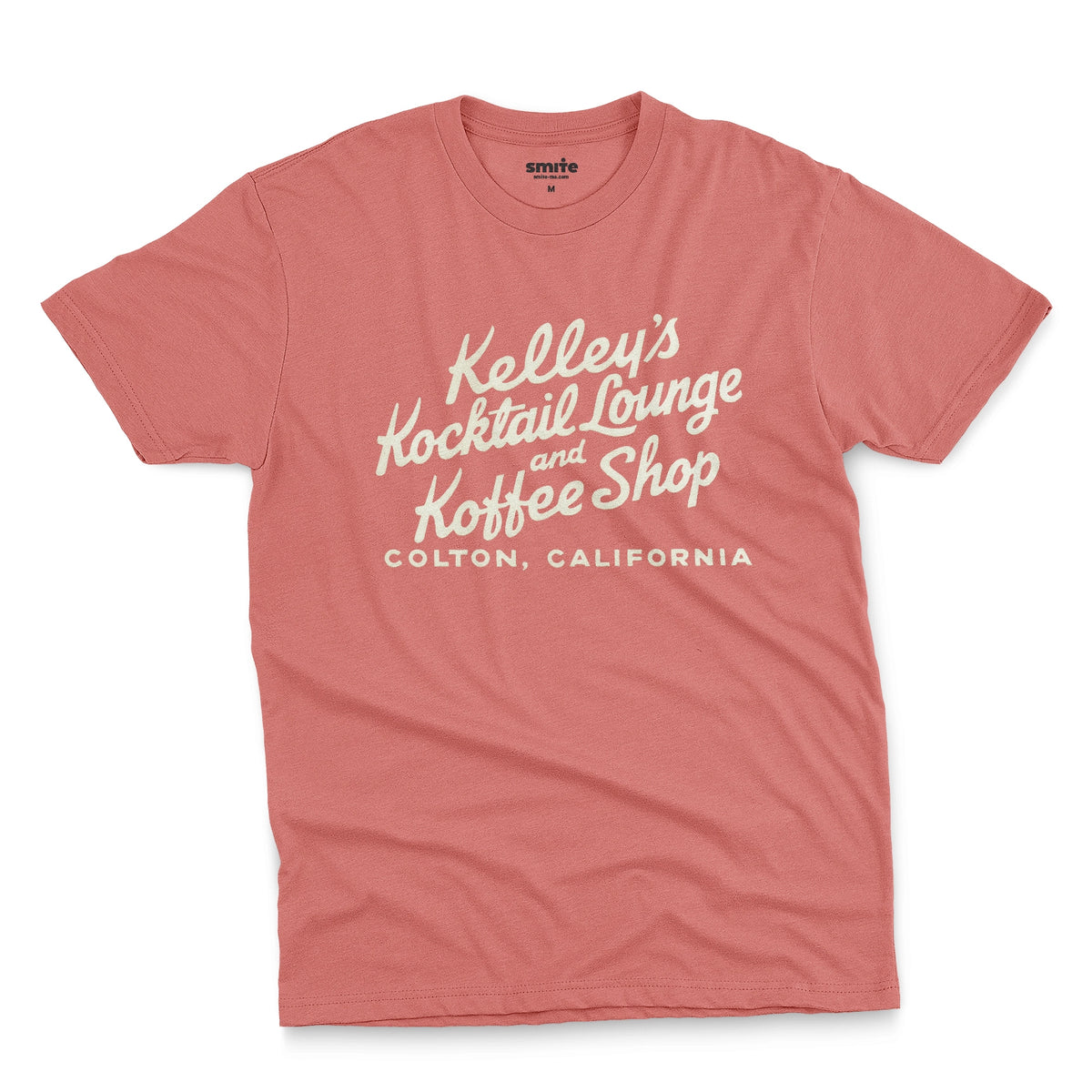 A coral pink t-shirt with a retro typographic advertisement for Kelley's Kocktail Lounge and Koffee Shop in Colton, California.