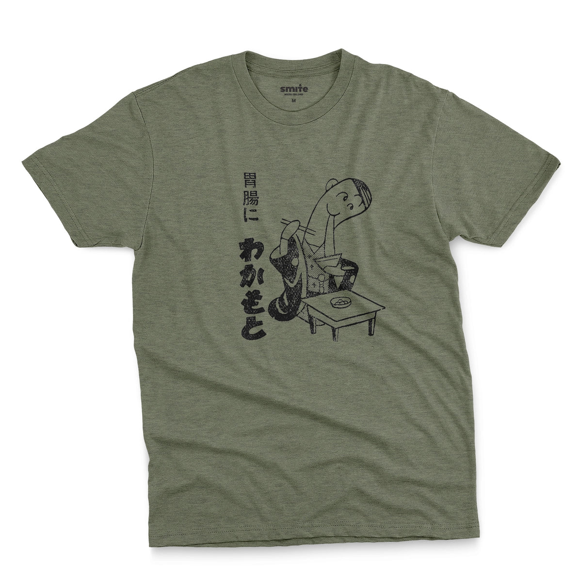 A green t-shirt with an advertisement for Wakamoto digestive tablets from a 1933 Japanese newspaper featuring a cartoon character in a kimono eating ramen next to Japanese text.