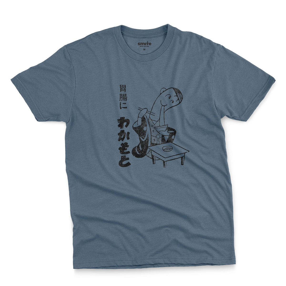 A bluet-shirt with an advertisement for Wakamoto digestive tablets from a 1933 Japanese newspaper featuring a cartoon character in a kimono eating ramen next to Japanese text.