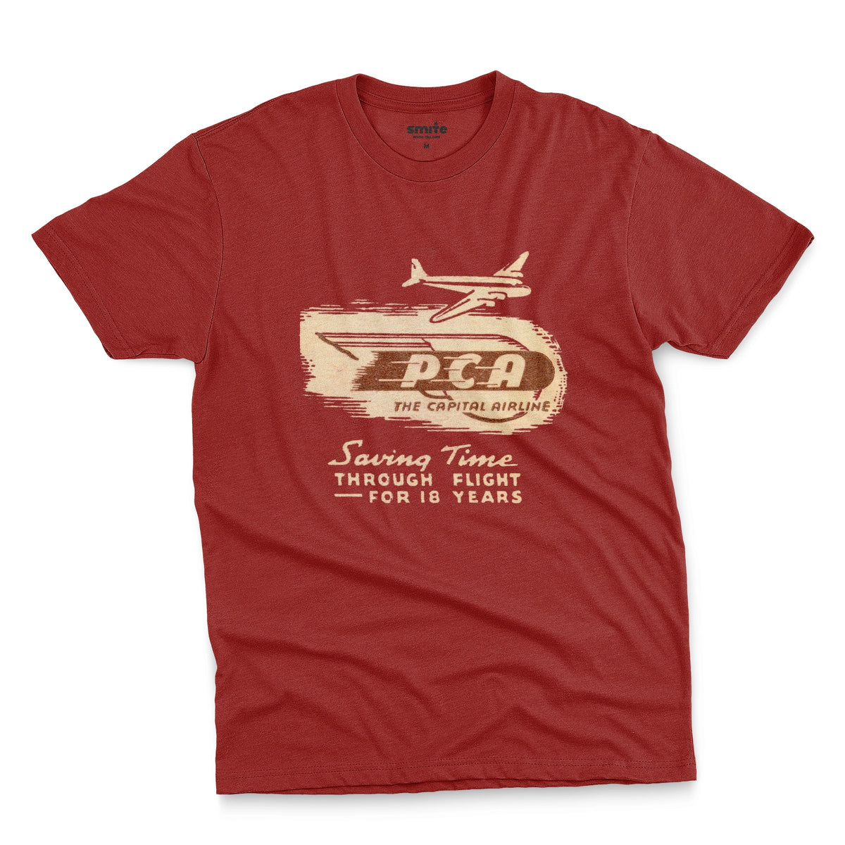 A red t-shirt featuring a vintage graphic advertisement for 'PCA THE CAPITAL AIRLINE'.