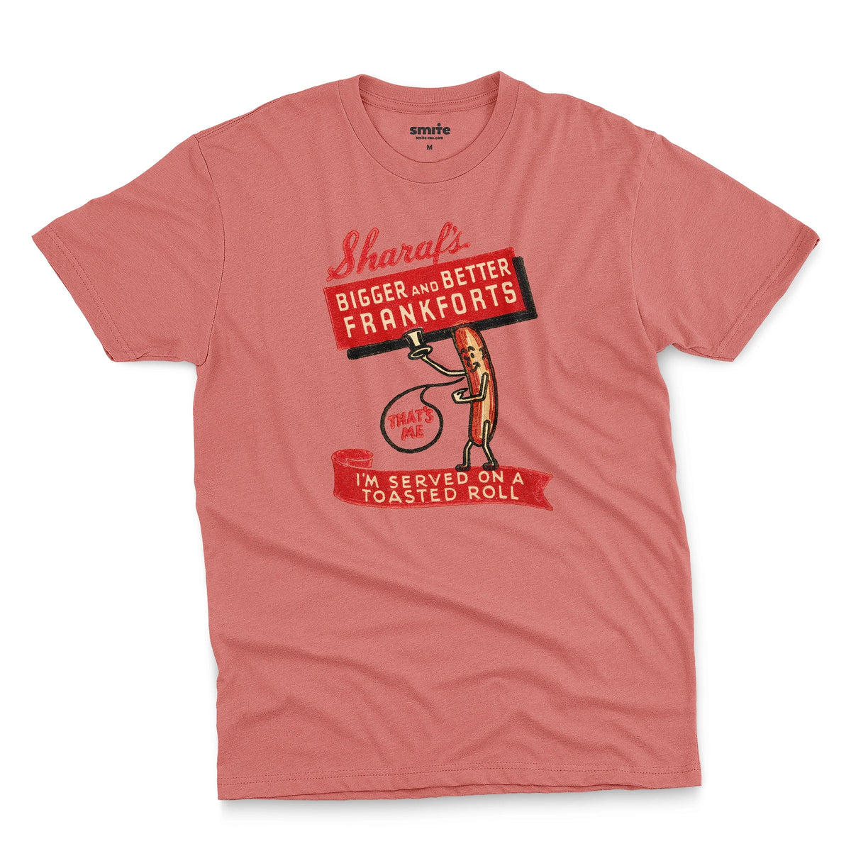 A coral pink t-shirt with a vintage graphic print of a hot dog character holding a sign that reads 'Sharaf's Bigger and Better Frankforts'.