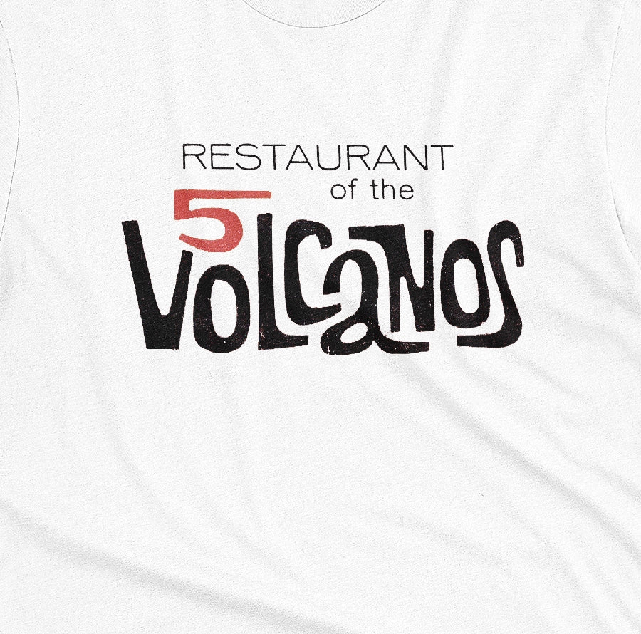 A white t-shirt with a vintage logo for the 'Restaurant of the 5 Volcanos', the Hawaiian Pavlion's restaurant at the New York World's Fair, 1964.
