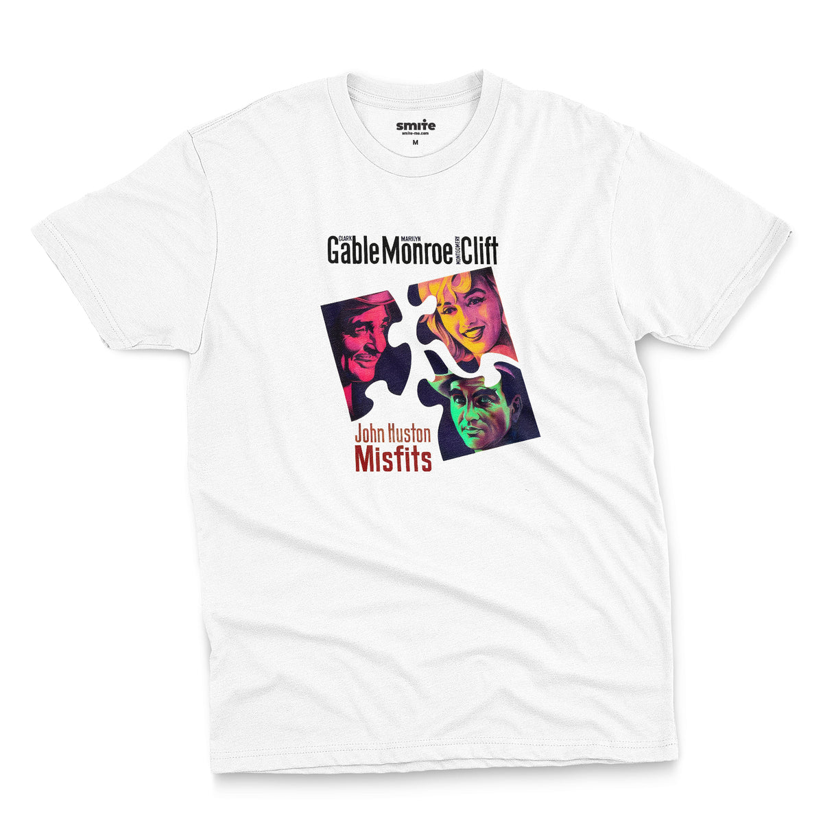 A white t-shirt featuring a colorful graphic advertisement for the movie The Misfits starring Clark Gable, Marilyn Monroe, and Montgomery Clift.