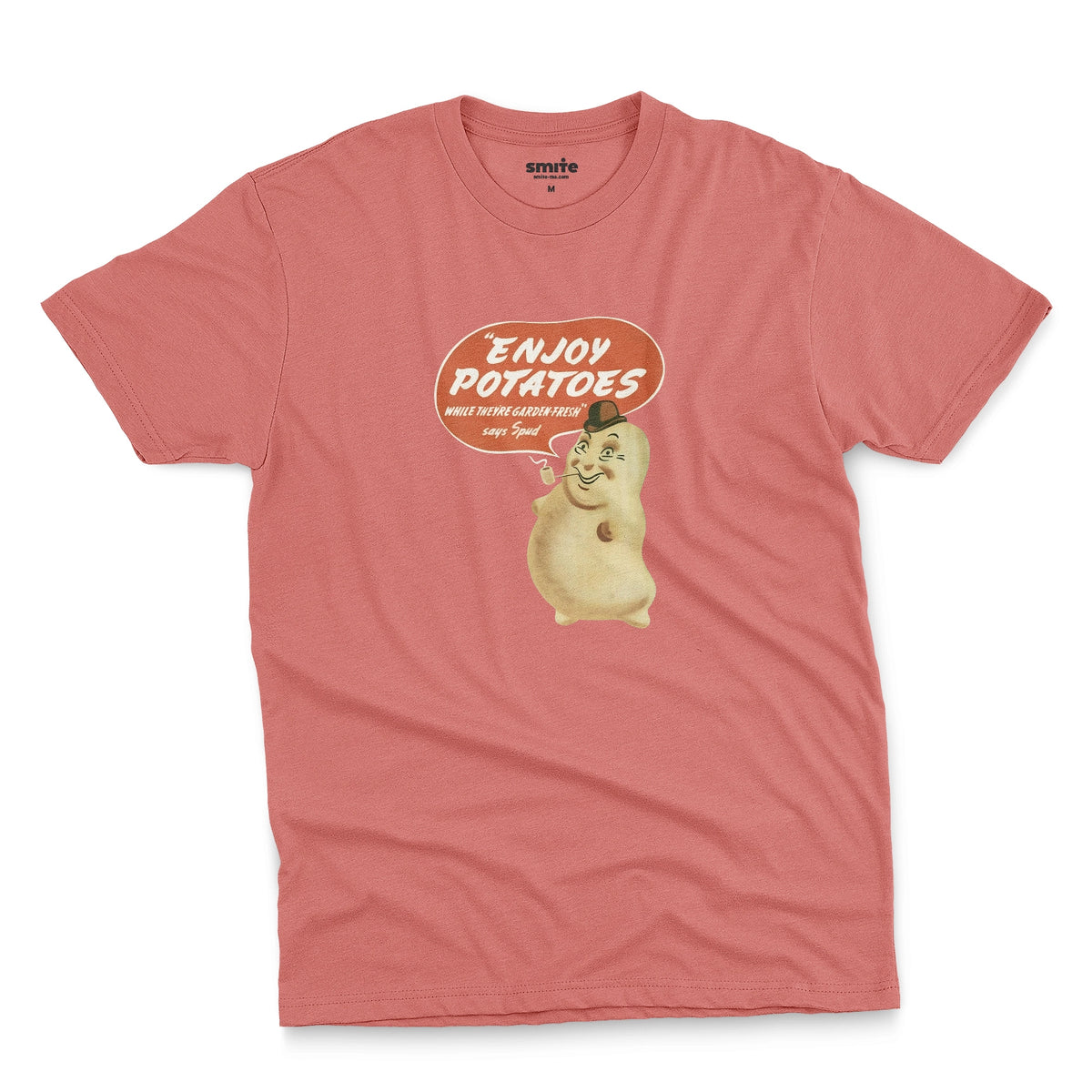 A coral pink t-shirt with a vintage graphic of a smiling potato character and a speech bubble that reads 'ENJOY POTATOES'.