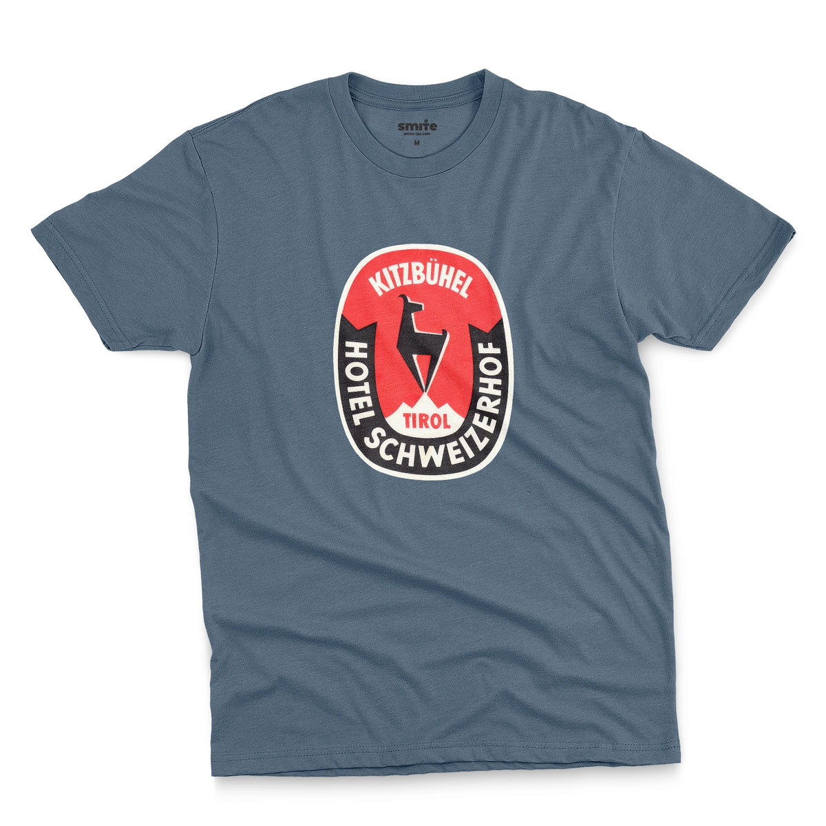 A blue t-shirt featuring a retro baggage label for the Hotel Schweizerhof in the Austrian Alps.