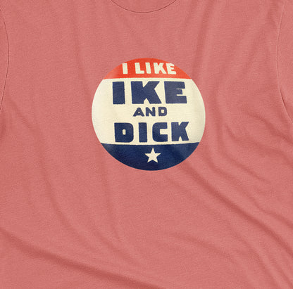 A coral pink t-shirt with  retro Eisenhower Nixon 1956 presidential campaign pin graphic.