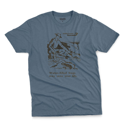 A blue t-shirt with a graphic print of an illustration from a World War 2 Australian Army handbook about finding and eating frogs.