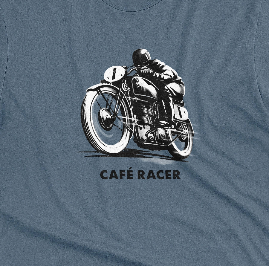 A blue t-shirt featuring a black and white graphic of a vintage motorcycle with a rider, with the text 'CAFÉ RACER' printed below it.