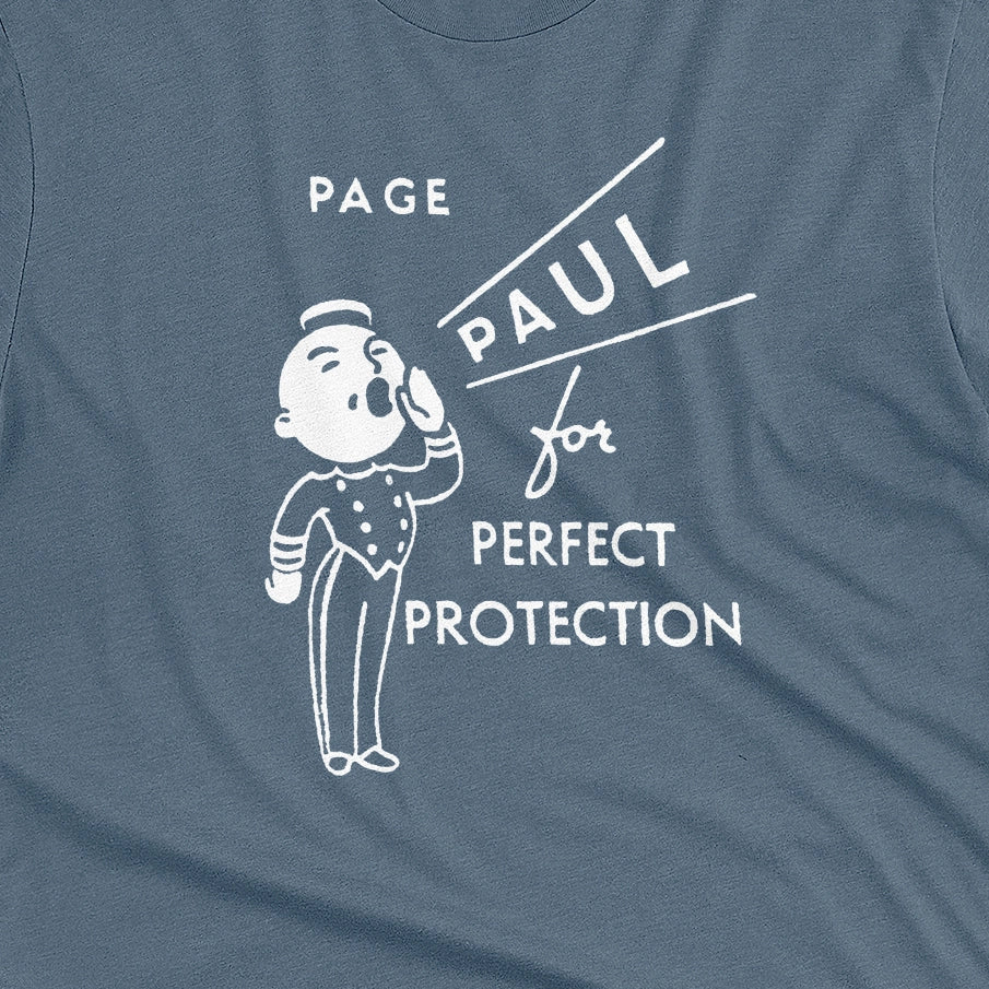 A blue t-shirt with a retro graphic print that features a cartoon character and the text 'PAGE PAUL for PERFECT PROTECTION'.