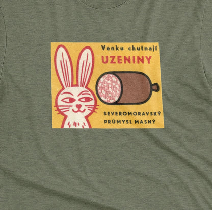 A green t-shirt with a vintage advertisement for the North Moravian Meat Industry sausage.