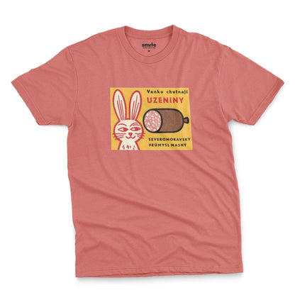 A coral pink t-shirt with a vintage advertisement for the North Moravian Meat Industry sausage.