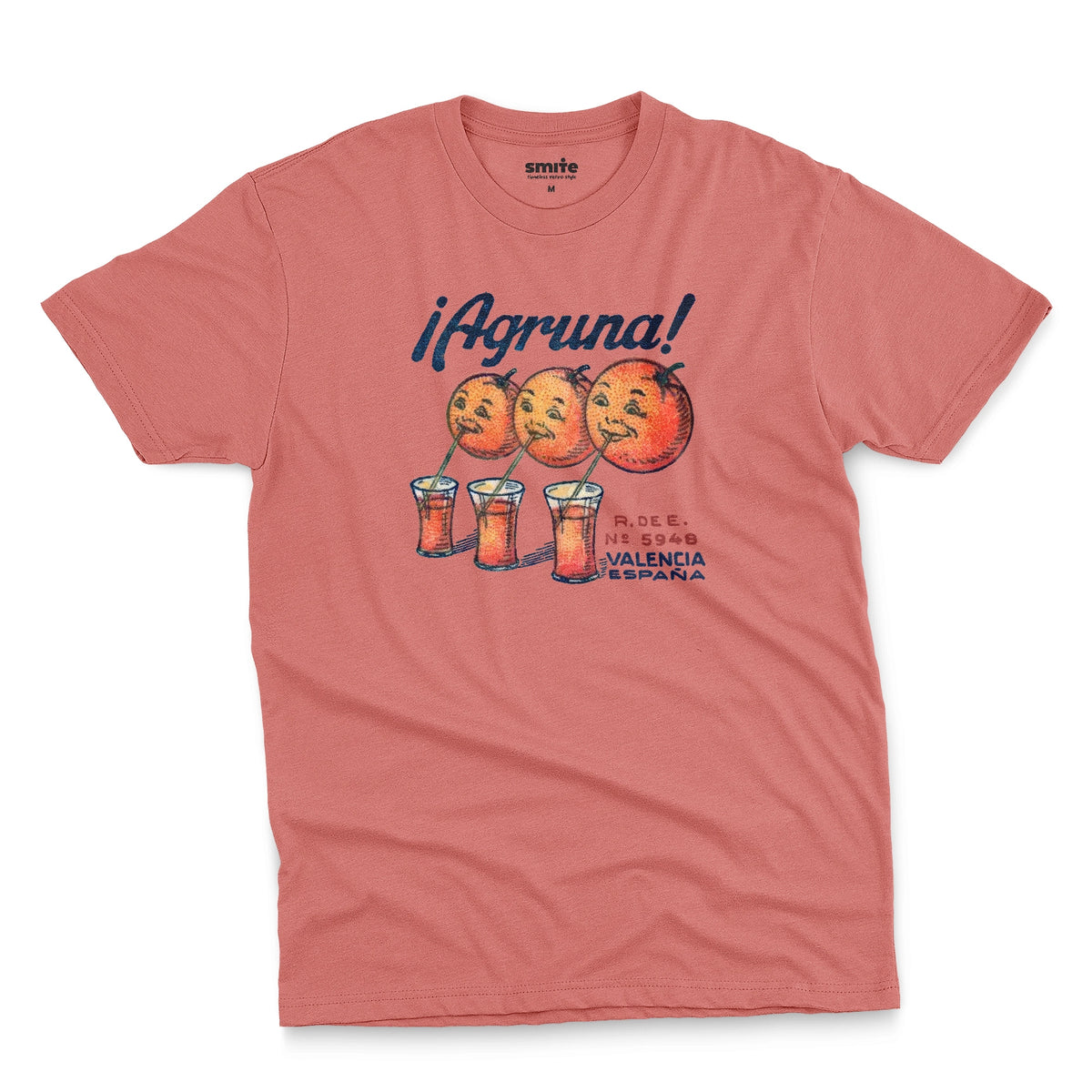 A coral pink t-shirt with a graphic print of Agruna brand fruit crate art from Valencia, Spain in the early 1900's.