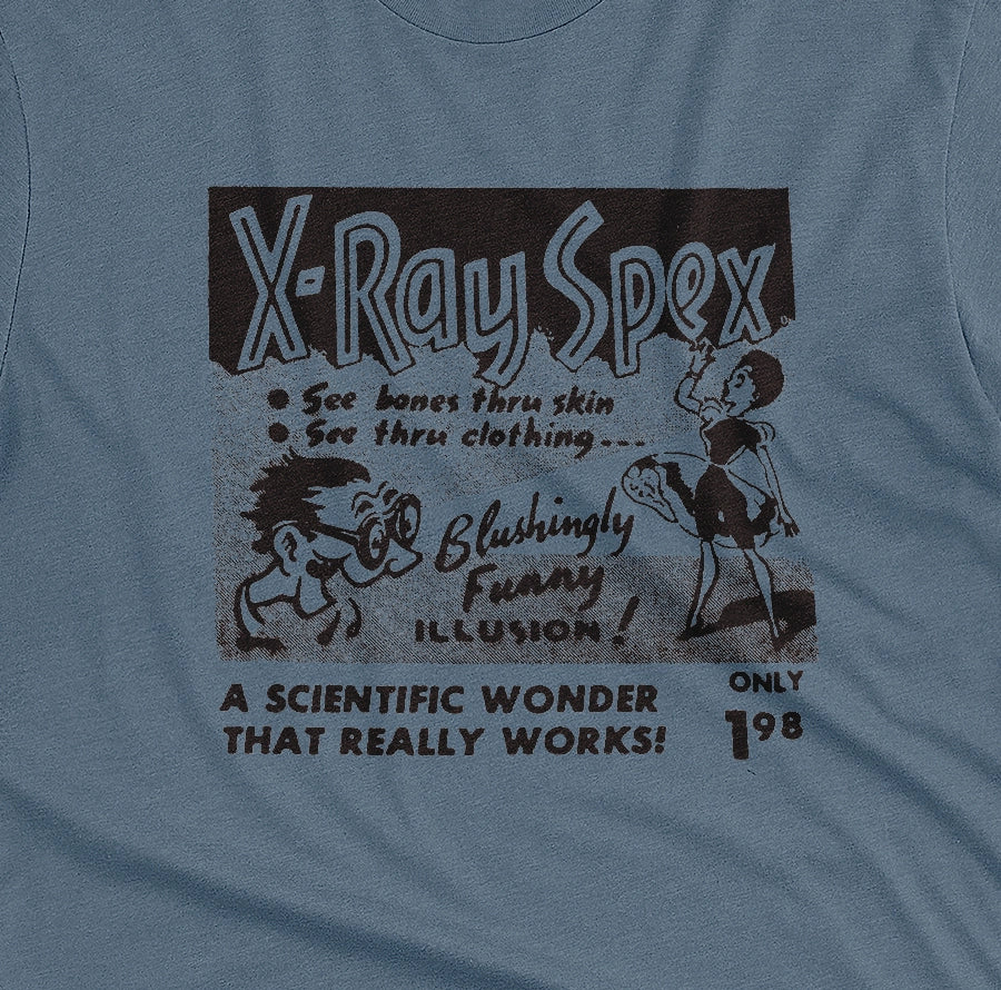 A blue t-shirt with a vintage advertisement for 'X-Ray Spex' commonly found in the back pages of 1960s comic books.