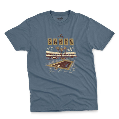 A blue t-shirt with a retro advertisement for 'the SANDS' hotel featuring a poolside scene.