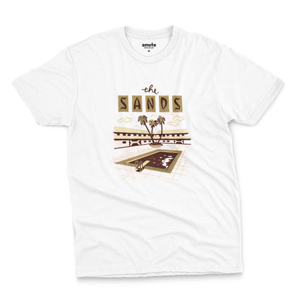 A white t-shirt with a retro advertisement for 'the SANDS' hotel featuring a poolside scene.