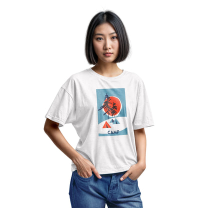A white t-shirt featuring a 1960s retro-style graphic print of pine trees in front of a large orange-red sun within a blue square, with small orange and blue tents below and the word 'CAMP'.