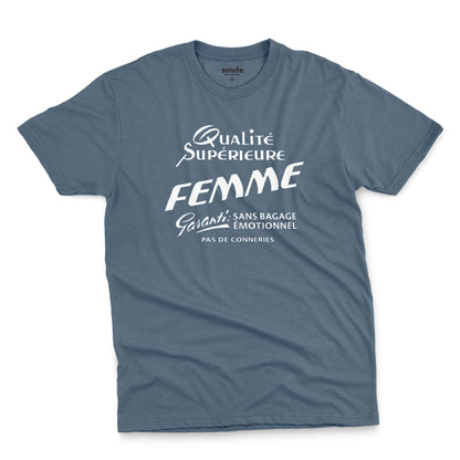 A blue t-shirt with white French text printed on the front. It translates as 'Superior Quality Woman Guarantee: No Emotional Baggage'.