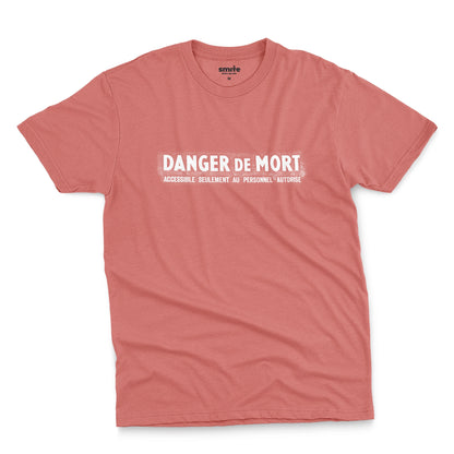 A coral pink t-shirt with the French 'Danger De Mort' or Danger of Death in English.