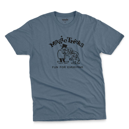 A blue t-shirt with a black graphic print on the front that reads 'Magic Tricks' above a cartoon of a magician and a spectator, with 'FUN FOR EVERYONE' printed below.
