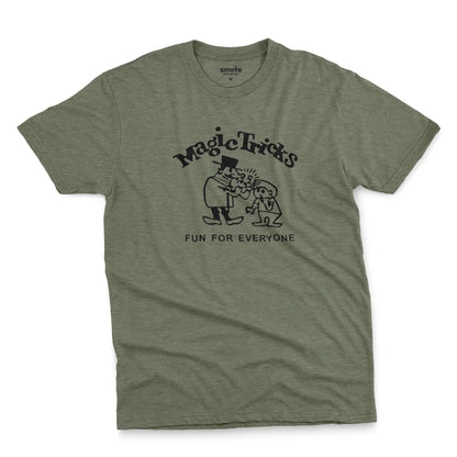 A green t-shirt with a black graphic print on the front that reads 'Magic Tricks' above a cartoon of a magician and a spectator, with 'FUN FOR EVERYONE' printed below.
