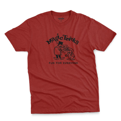A red t-shirt with a black graphic print on the front that reads 'Magic Tricks' above a cartoon of a magician and a spectator, with 'FUN FOR EVERYONE' printed below.