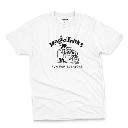 A white t-shirt with a black graphic print on the front that reads 'Magic Tricks' above a cartoon of a magician and a spectator, with 'FUN FOR EVERYONE' printed below.