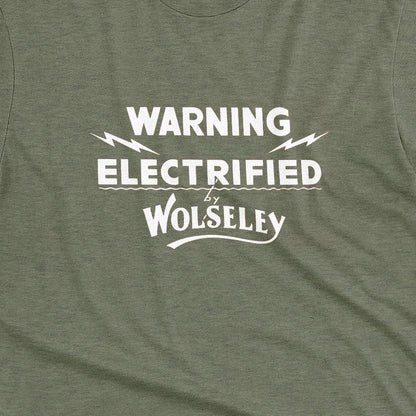 A green t-shirt with vintage graphics from an electric fence sign for the Wolseley brand from the early 1900s.