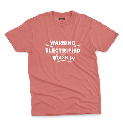 A coral pink t-shirt with vintage graphics from an electric fence sign for the Wolseley brand from the early 1900s.