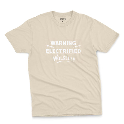 A beige t-shirt with vintage graphics from an electric fence sign for the Wolseley brand from the early 1900s.
