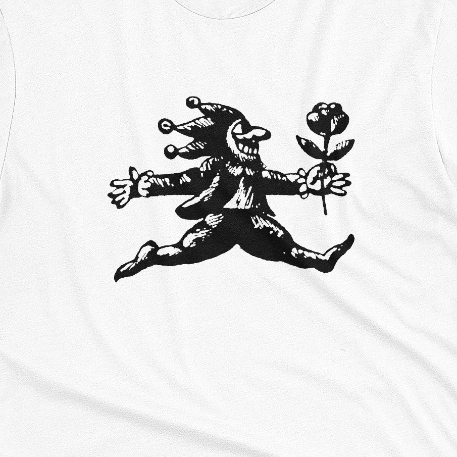 A white t-shirt with an engraved illustration of a jester holding a rose from the early 1900s.
