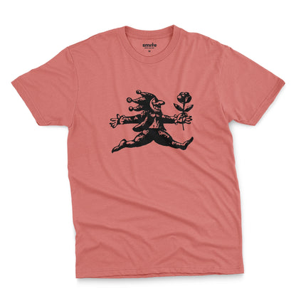 A coral pink t-shirt with an engraved illustration of a jester holding a rose from the early 1900s.