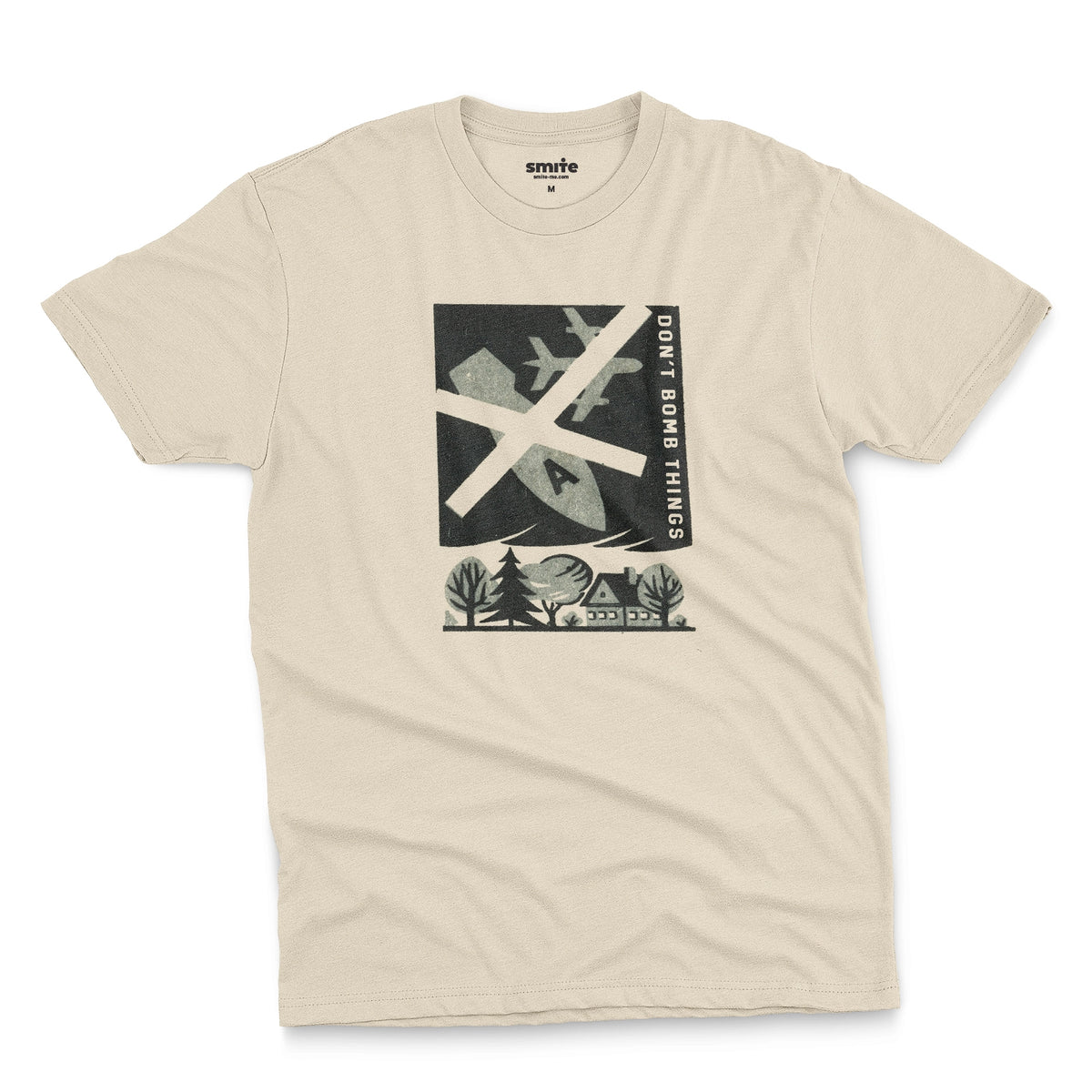 A beige t-shirt with a retro graphic print of an anti-war message featuring a cross, a plane, a house, and the text 'DON'T BOMB THINGS'.