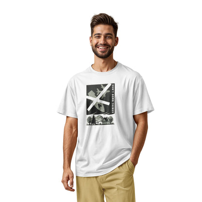 A white t-shirt with a retro graphic print of an anti-war message featuring a cross, a plane, a house, and the text 'DON'T BOMB THINGS'.