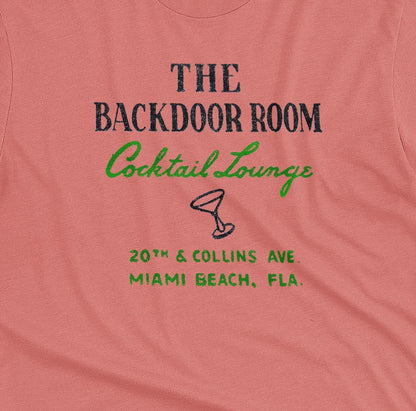 A coral pink t-shirt with a retro advertisement for 'THE BACKDOOR ROOM Cocktail Lounge' on Miami Beach, Florida.