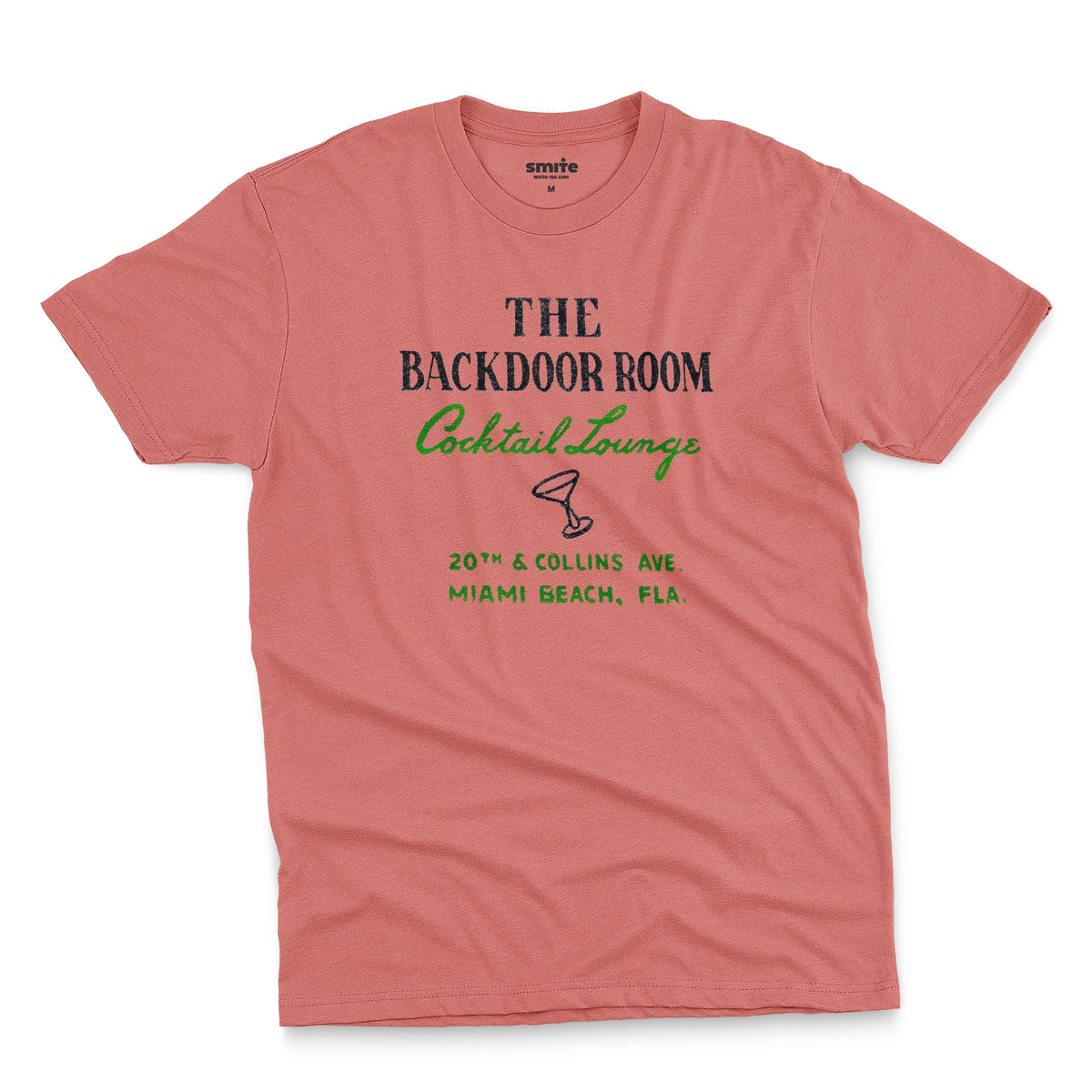 A coral pink t-shirt with a retro advertisement for 'THE BACKDOOR ROOM Cocktail Lounge' on Miami Beach, Florida.